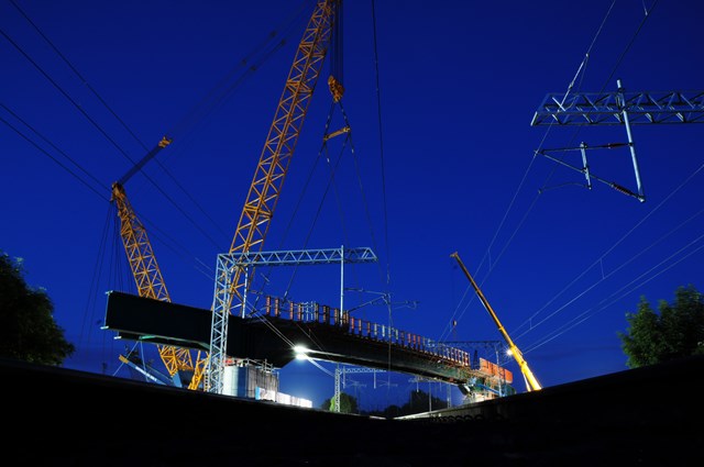 Hitchin flyover main span lifted into position: Shot from between the tracks of the East Coast Main Line, the 30 ton main span of the flyover is lifted into position.