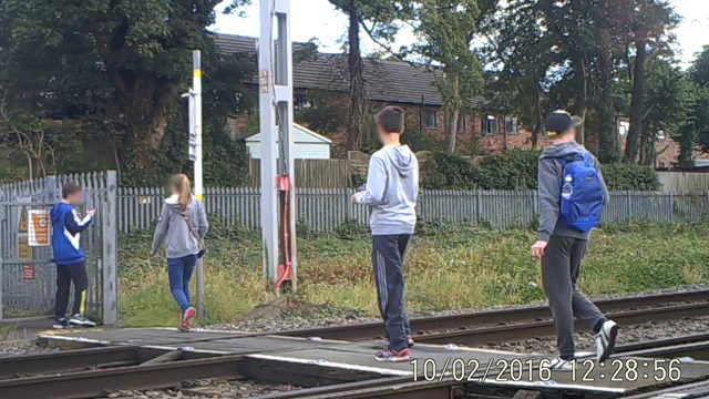 Four children crossing Stone station level crossing