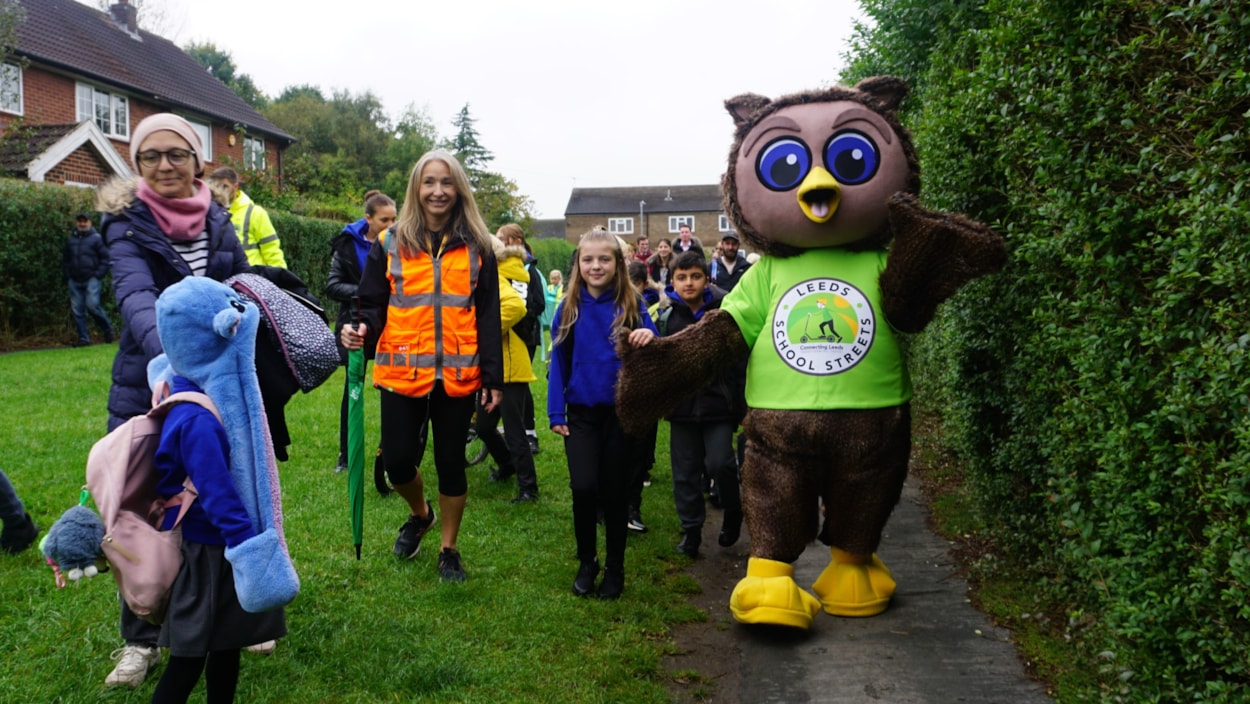 Leeds City Council safe and sustainable travel mascot, Arlo the Owl, guiding pupils from Ireland Wood primary school across the School Street: Leeds City Council safe and sustainable travel mascot, Arlo the Owl, guiding pupils from Ireland Wood primary school across the School Street