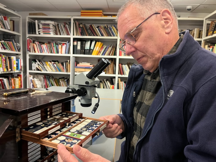 Microscope slides: Volunteer Stephen Crabtree uses a microscope to study the slides at the Leeds Discovery Centre.
Stored in small, wooden trays, the collection is thousands strong and is being painstakingly reviewed as part of a volunteer project.