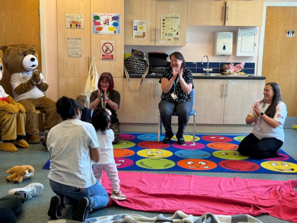 Pictured from left to right are Best Start in Life Development Worker Melanie Parry, Family Time Worker Early Help Mel Smith and Best Start in Life Neighbourhood group Outreach Worker Kara Wilcock, with children enjoying the teddy bears' picnic at Ribbleton Family Hub's one stop shop