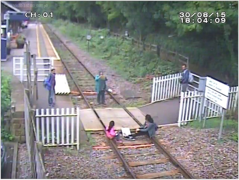 Rail safety warning as crossing users seen taking selfies and lying on the track in Derbyshire: Matlock Bath - Children sit on rails while mother takes picture