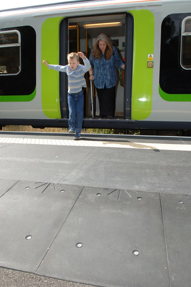 ST ALBANS ABBEY RAIL USERS HAPPY TO GET THE HUMP: Young boy jumping down onto new 'hump' at St Albans Abbey