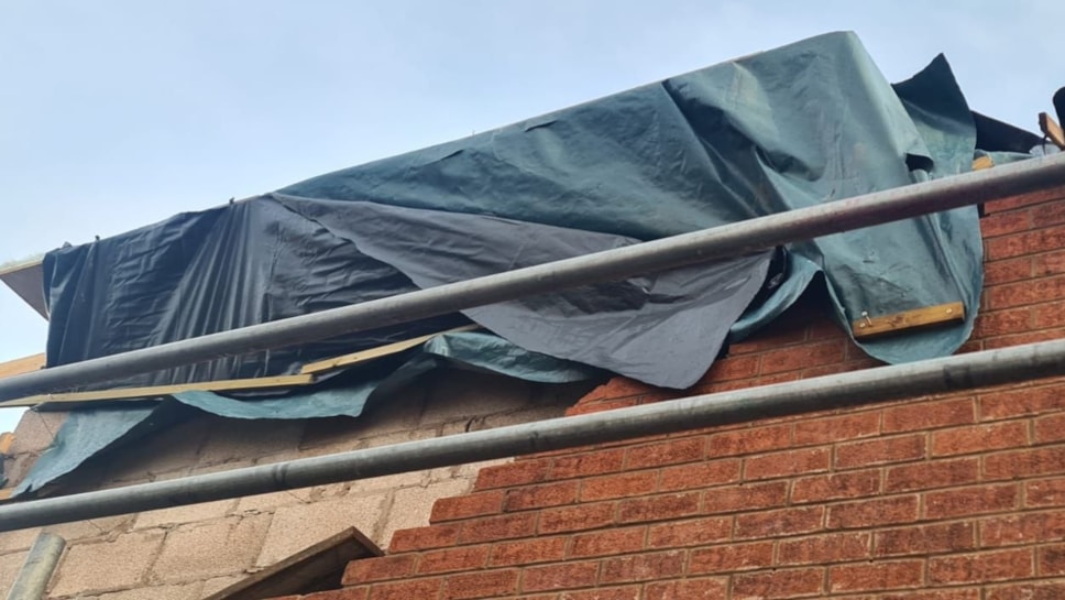 One of the badly repaired roofs