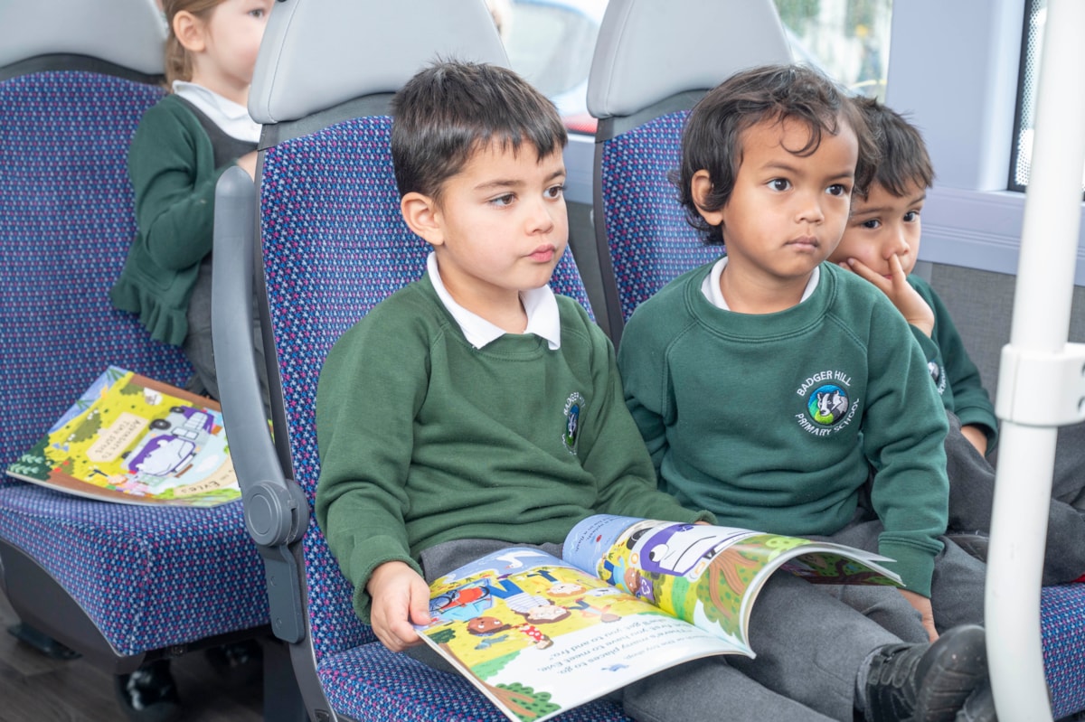 Children on bus with book