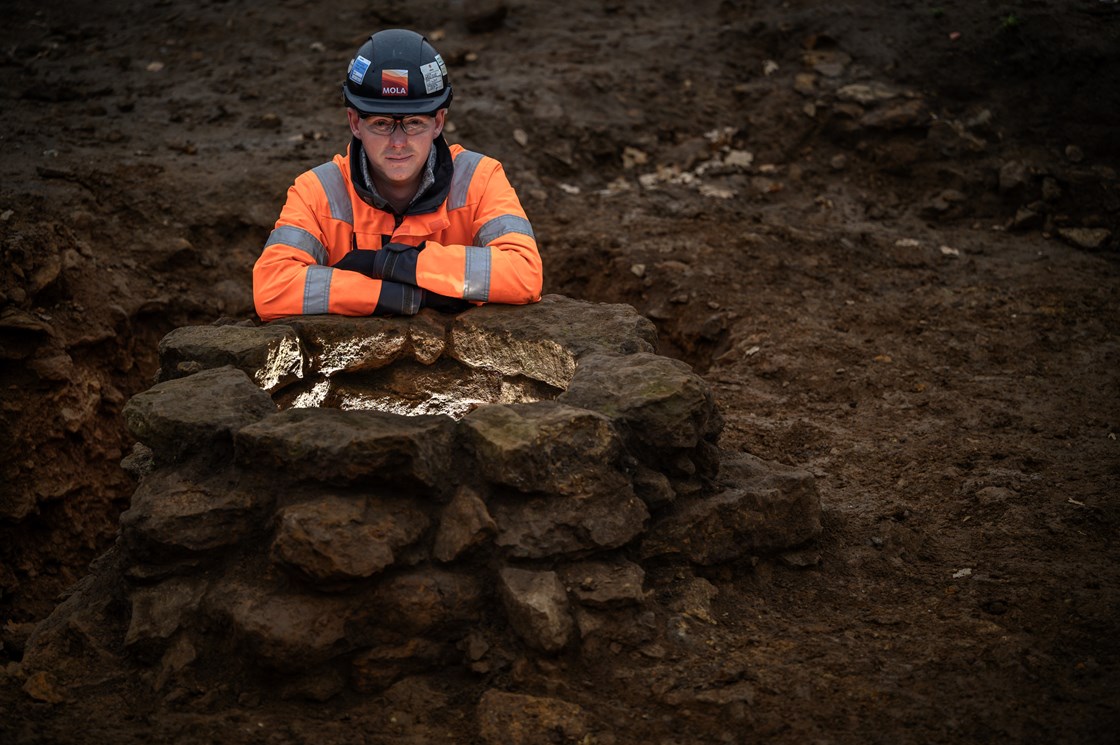 Roman well uncovered during the archaeological excavation of a Roman trading settlement, Blackgrounds, South Northamptonshire-2: James West, Site Manager MOLA, by one of four wells uncovered during the archaeological excavation of a wealthy Roman trading settlement, known as Blackgrounds, in South Northamptonshire. 

Tags: Archaeology, Roman, Northamptonshire, Phase One, History, Heritage