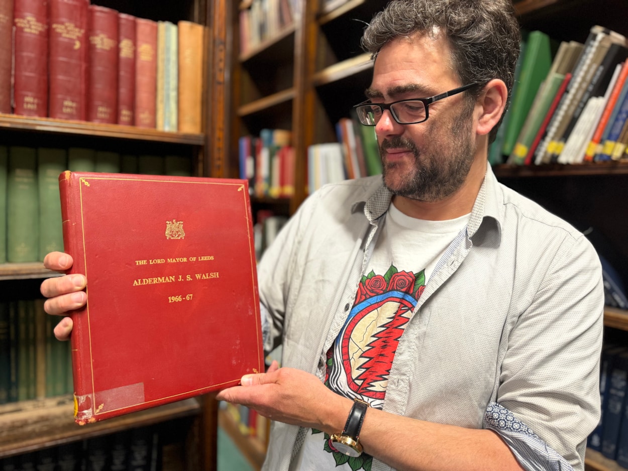 World Cup heroes at library: The book and photograph date from August 3, 1966 when then Lord Mayor of Leeds, Alderman Joshua S Walsh, hosted a prestigious civic reception honouring the victorious players at Leeds Civic Hall.
Pictured is special collections librarian Antony Ramm with the album.