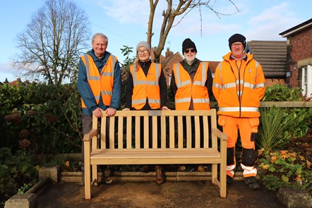 This image shows the poppleton memorial bench alongside station volunteers