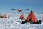 Twin Otter flying past a field camp. Morag Hunter.: Twin Otter flying past a field camp. Morag Hunter.