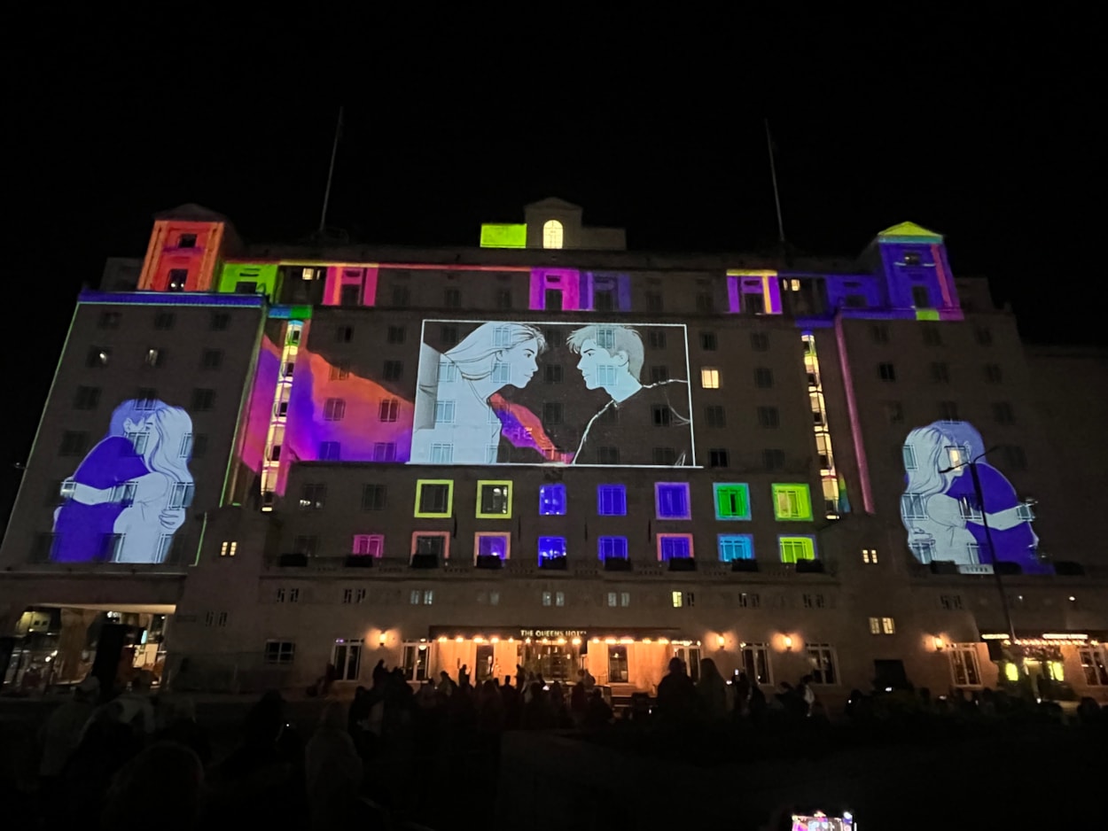 Light Night 2025: Among the captivating artworks which lit up the city last night was a spellbinding projection on City Square’s iconic Queens Hotel Entitled One Second Lovestory, created by German artist Dirk Rauscher.
Celebrating 200 years of the modern railway, the piece captures a romantic moment in time when two people’s eyes meet at a busy train station and is sponsored by Markel.