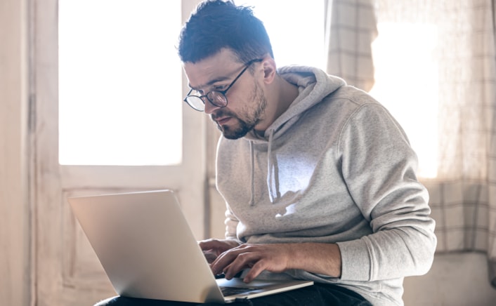man with glasses reading report (image)