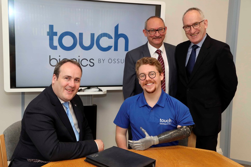 (Sitting l-r) Paul Wheelhouse, Scottish Government Minister for Business, Innovation & Energy, Patrick Kane, patient ambassador for Touch Bionics (Standing l-r) Hugh Gill, Vice President of Research & Development at Touch Bionics, Michael Cannon, Head of Innovation & Enterprise Services at Scottish Enterprise