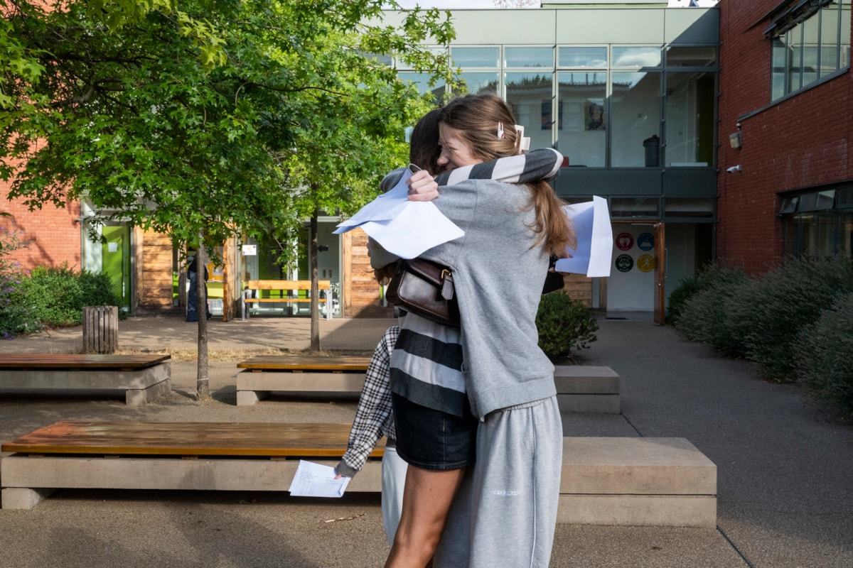 Two students from Clapton Girls' Academy hugging after receiving their GCSE results. Credit: Sean Pollock - Hackney Council