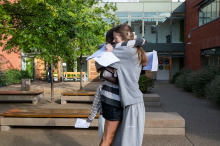 Two students from Clapton Girls' Academy hugging after receiving their GCSE results