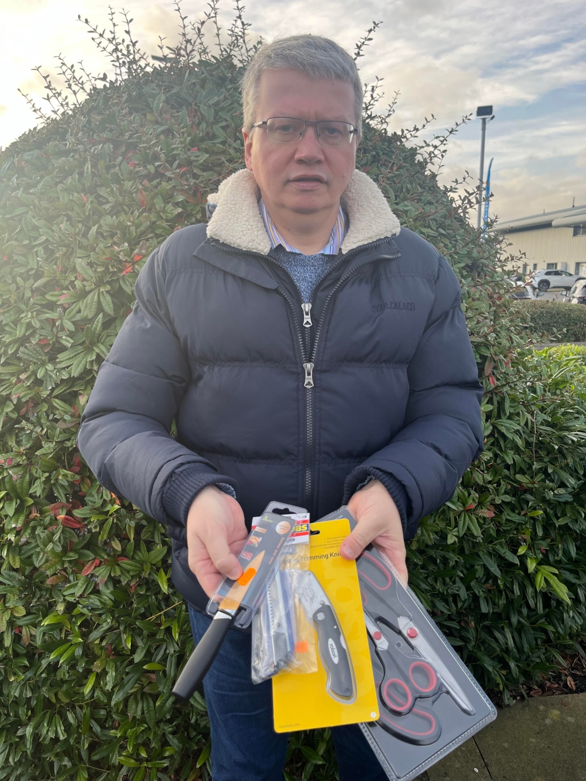 Lancashire County Councillor Michael Green, cabinet member for Health and Wellbeing, holds the illegally sold knives that were seized during Operation Sceptre