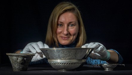 Lyndsay McGill, Curator of Renaissance and Early Modern History at National Museums Scotland with the 17th century silver trumpet bell, mazer and quaich. Photo © Phil Wilkinson WEB