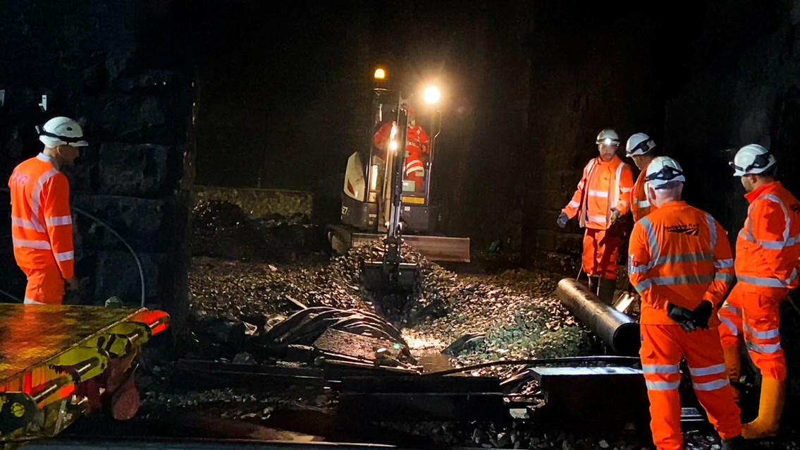 Excavator digging out new drainage channel in Cowburn Tunnel