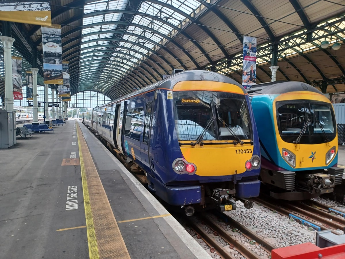 Image shows a Northern train and TransPennine Express train at Hull station