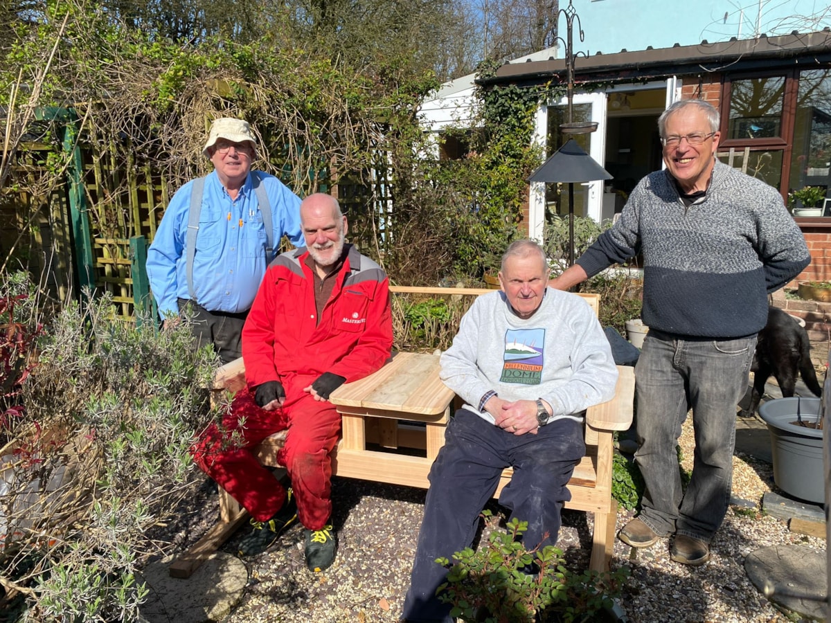 Members of Greater Garstang Men's Shed with a bench that they made