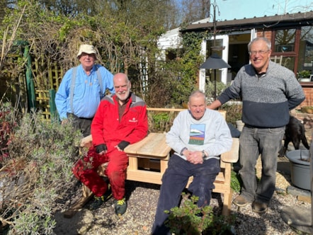 Members of Greater Garstang Men's Shed with a bench that they made