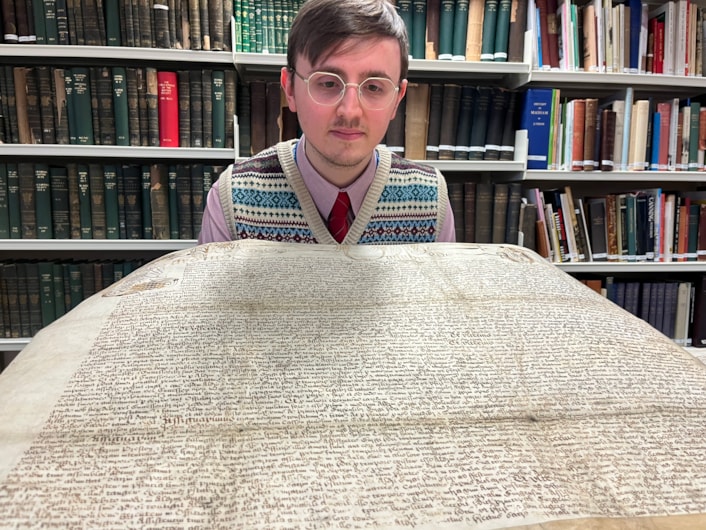 The Leeds Charter: Alex Pearson, archives assistant with West Yorkshire Archive Service with the copy of the Leeds Charter and  a second ornate charter, granted decades later in 1661 by Charles II.
The granting of the prestigious charter changed the course of the city’s history, laying the foundations of modern-day Leeds by incorporating it as a “free borough” and a “body corporate and politic.”