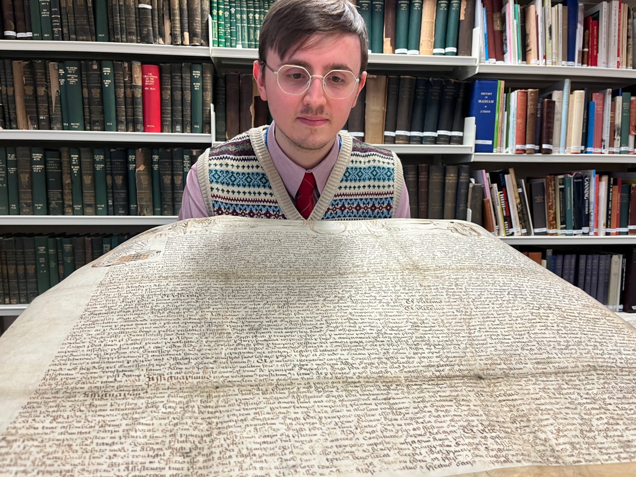 The Leeds Charter: Alex Pearson, archives assistant with West Yorkshire Archive Service with the copy of the Leeds Charter and  a second ornate charter, granted decades later in 1661 by Charles II.
The granting of the prestigious charter changed the course of the city’s history, laying the foundations of modern-day Leeds by incorporating it as a “free borough” and a “body corporate and politic.”