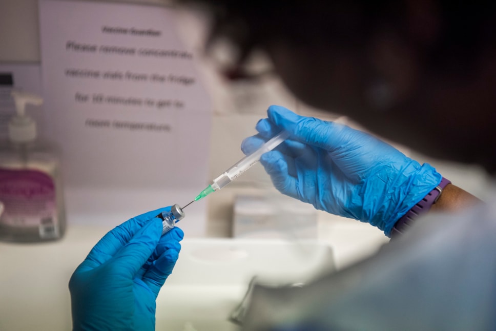 Hackney nurse draws up the covid-19 vaccine into a syringe
