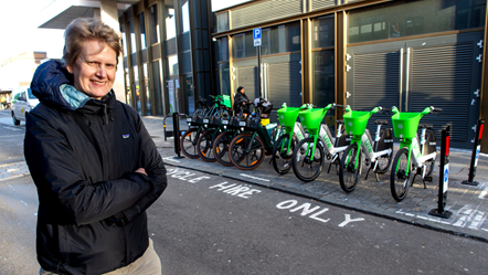 Councillor Champion poses in front of the cycle hire bay
