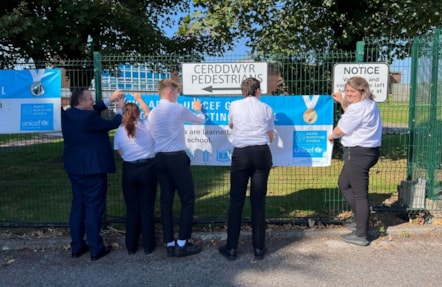 Milford Haven School pupils display their Unicef Gold news