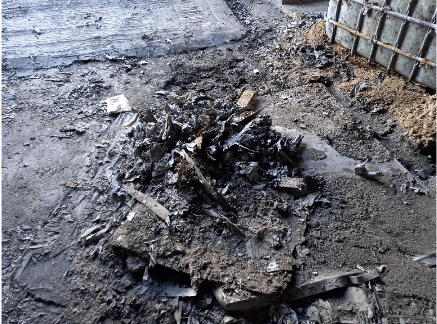 Damaged area of floor in left hand side of unit (as facing), covered by metal sheet and other debris