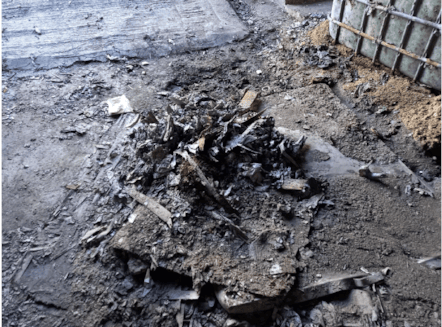 Damaged area of floor in left hand side of unit (as facing), covered by metal sheet and other debris