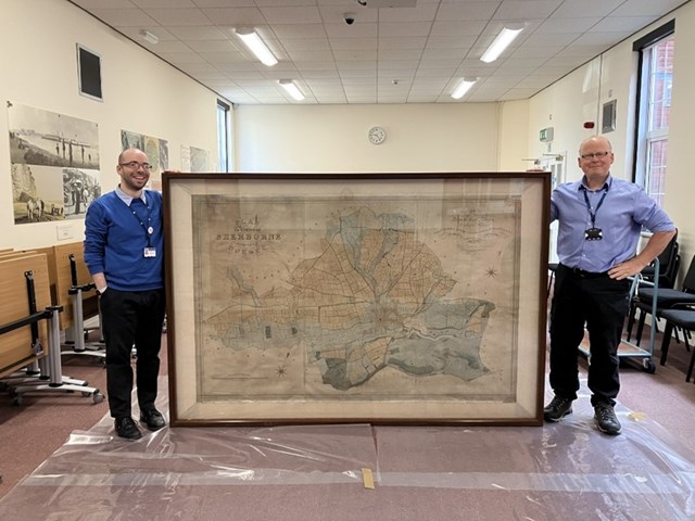 Staff at Dorset History Centre with the 1834 Percy map of Sherborne