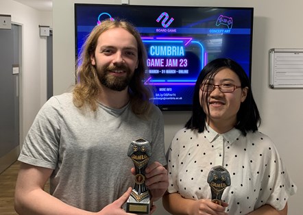 Two University of Cumbria GameJam 2023 award winners with their trophies