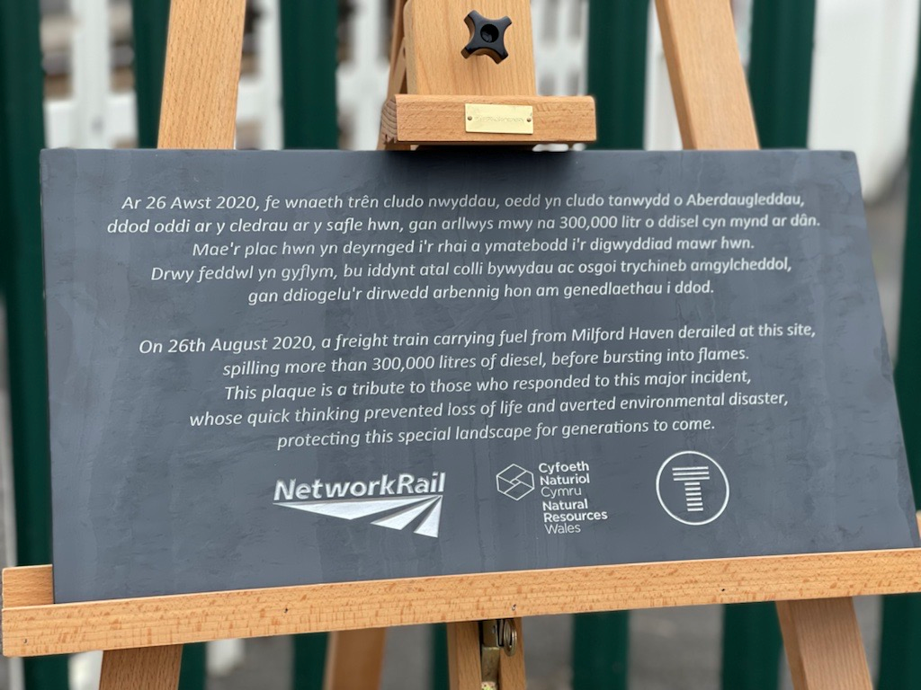 Llangennech anniversary plaque-2: The first anniversary plaque donated to the village of Llangennech by Network Rail, Natural Resources Wales and Transport for Wales. The plaque is a thank you to all who responded to this incident and the community.