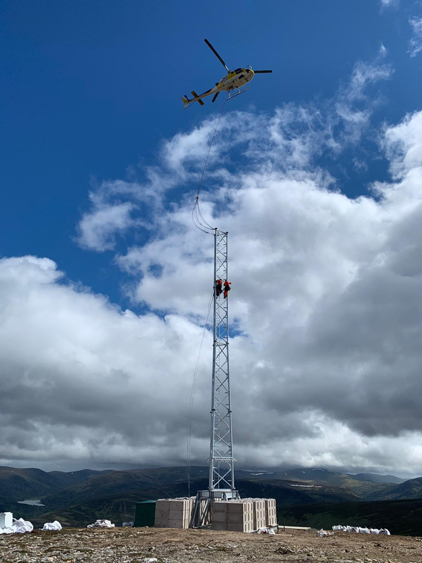 Engineers installing telecoms mast