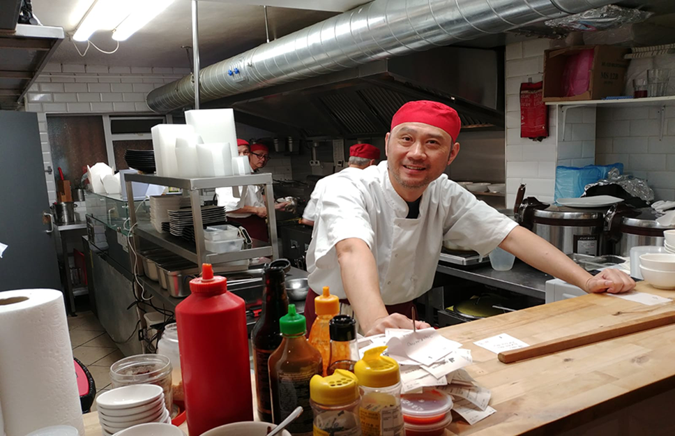 Chefs working inside Hot Wok restaurant in Archway