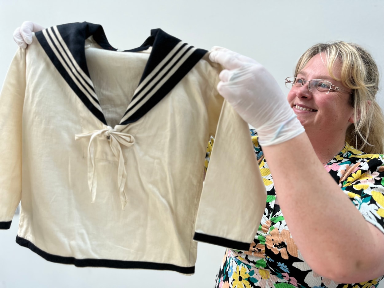 Sailor suits: Gemma Brown, site development officer at the Leeds Discovery Centre, with one of the eye-catching sailor suit style outfits in the Leeds collection.
The eye-catching naval attire includes a classic range of blue and white outfits, dresses and bellbottom trousers, looks which became hugely popular for children during the late 19th and early 20th centuries.
The suits are among an array of historic fashions which will be explored in an upcoming workshop at Leeds Discovery Centre looking back on centuries of fabulous clothes and costumes.