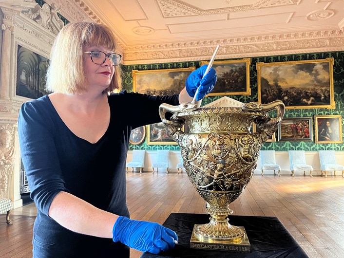 Temple Newsam Treasures: Leeds Museums and Galleries conservator Emma Bowron with the silver gilt Doncaster Gold Cup 1828-29, part of an array of silverware that has been conserved for a revamped display at Temple Newsam House.