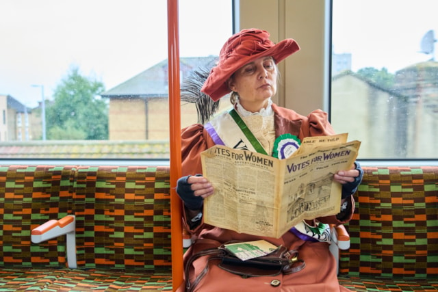 TfL Image - An actress from Zoom through History dressed as Suffragette leader Emmeline Pankhurst on what will become the Suffragette line