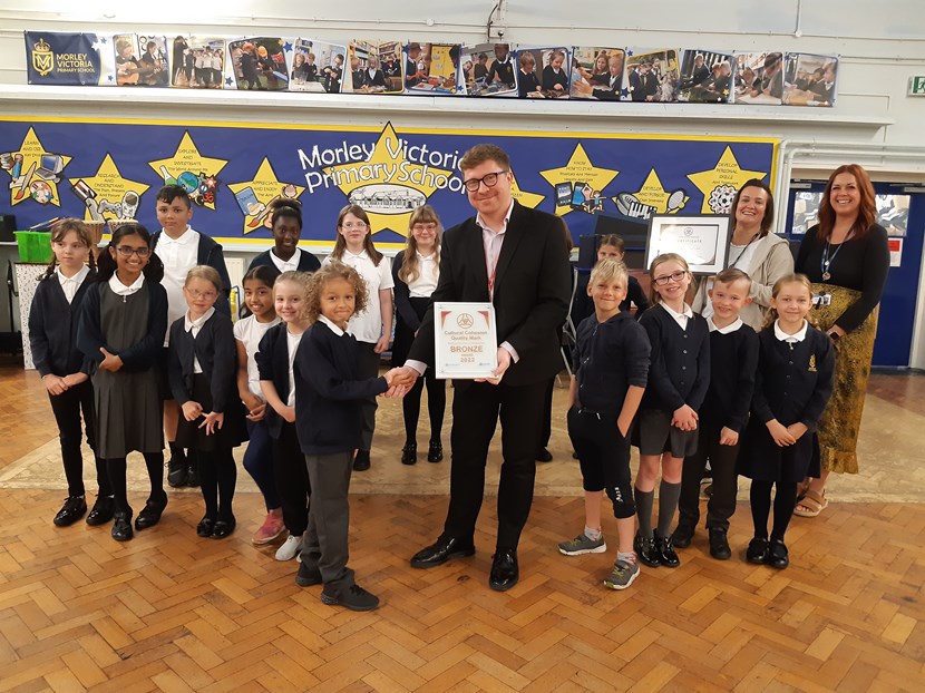 First school in Leeds receives quality mark for its work to promote diversity: Cllr Pryor with the school's 'Diversity Developers' HT Jo Wood and CCQM school lead Candy Evans-2