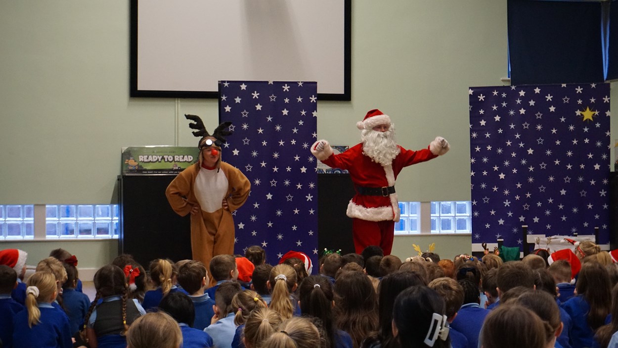 Santa and Rudolph in action: Santa and Rudolph performing their road safety pantomime in Thorpe Primary School hall. In the foreground are pupils of the school.