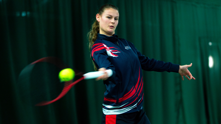 Lily Mills hitting a ball at the Islington Tennis Centre
