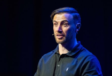 A photo of former footballer Zander Murray delivering a talk.