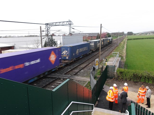 Freight train crossing the old footpath crossing at Brock