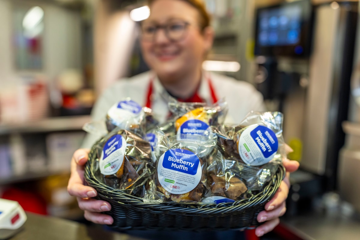 LNER COLLEAGUE HOLDING A BASKET OF FREE SWEET TREATS
