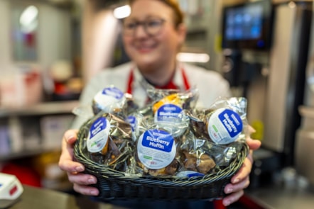 LNER COLLEAGUE HOLDING A BASKET OF FREE SWEET TREATS