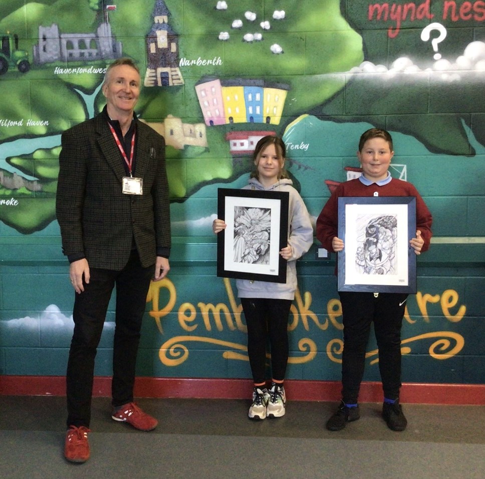 Margaret Jones’ son Mark, is pictured with Prendergast CP School pupils and some of the original artwork.