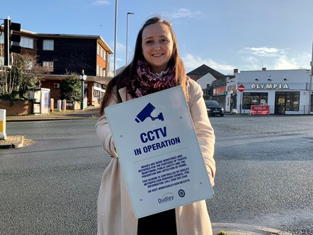 Laura Taylor holding a CCTv sign in Lye