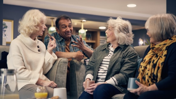 McCARTHY STONE’S PART EXCHANGE HELPS SURREY AND OXFORDSHIRE RETIREES AVOID THE DRAMA OF PROPERTY CHAINS WHEN DOWNSIZING TO A NEW HOME: McCarthy Stone homeowners chatting lounge