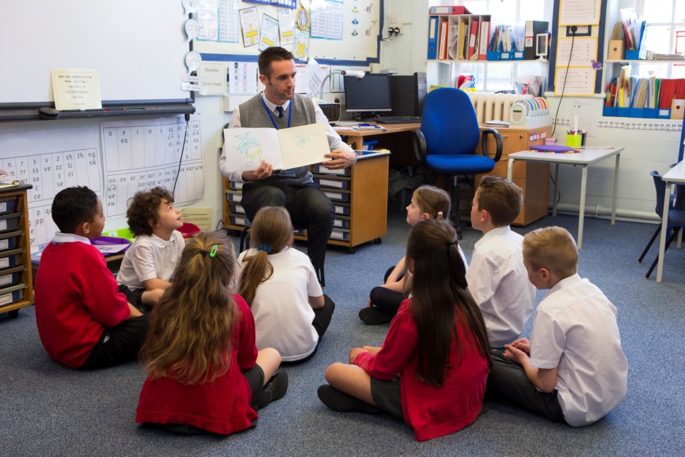 Education -  teacher reading to class of children